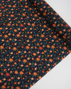Tecido Crepe Koshibo Leve Italiano Campo de Flores Laranja e Preto