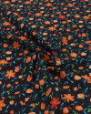 Tecido Crepe Koshibo Leve Italiano Campo de Flores Laranja e Preto
